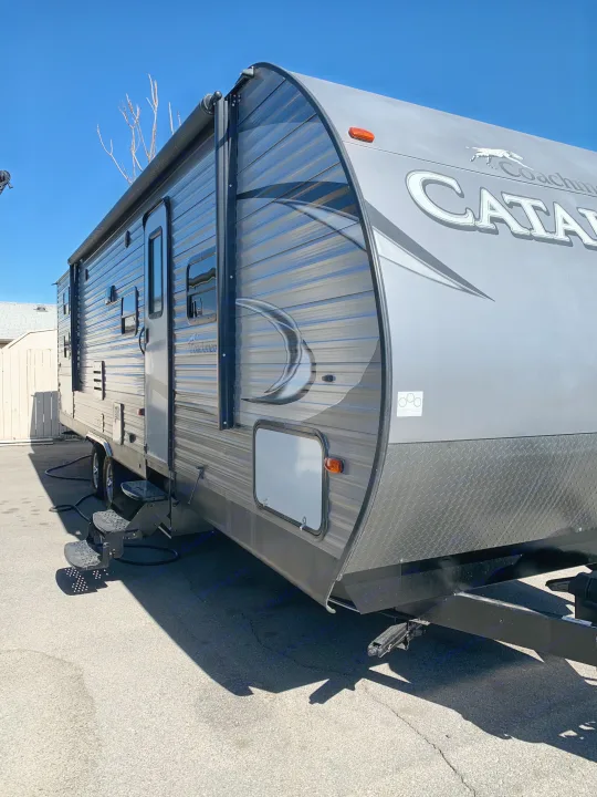This gray Coachmen Catalina travel trailer is an ideal RV rental, featuring an awning and accessible steps.. Coachmen Other 2018