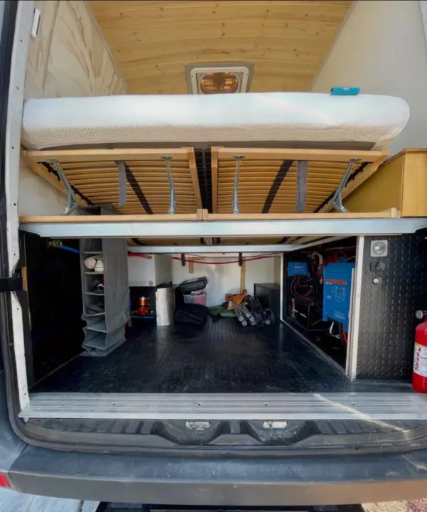 RV rental van conversion: Elevated bed, spacious storage below, and integrated electrical/water systems. A well-equipped camper van.. Mercedes Sprinter 2012