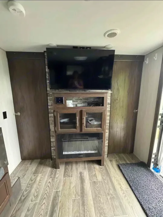 This RV rental features a cozy living area with a large TV, electric fireplace, and ample storage, perfect for your next trip.. Forest River Cherokee Grey Wolf 2019