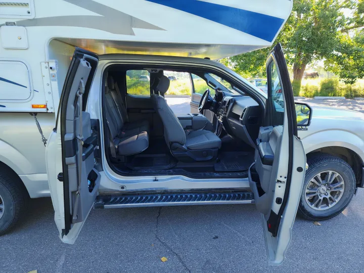 RV rental: Silver pickup truck camper with open doors revealing the full interior, dashboard & seats.. Ford Ford F150 2017