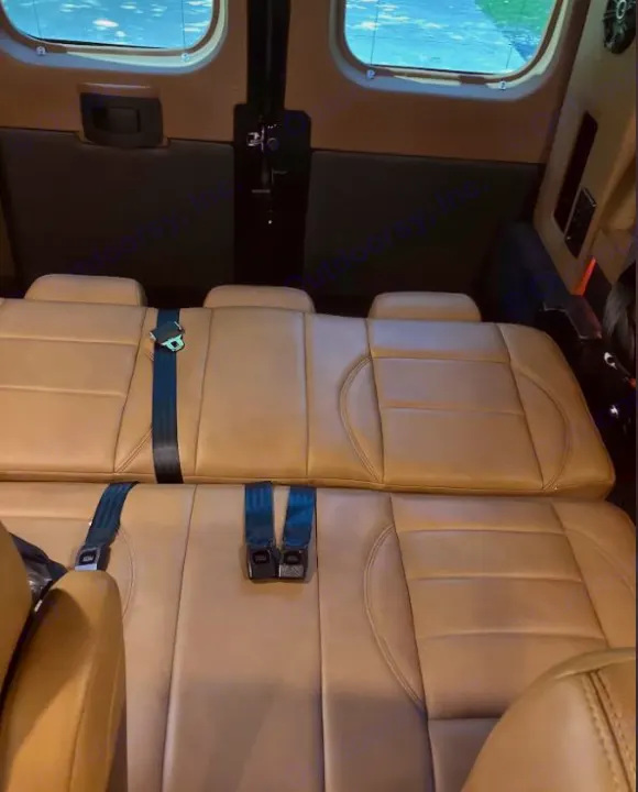 Inside an RV rental: plush tan seats with safety belts, offering comfort & space for travel. Windows visible.. Dodge Sprinter 2500 170ext 2021