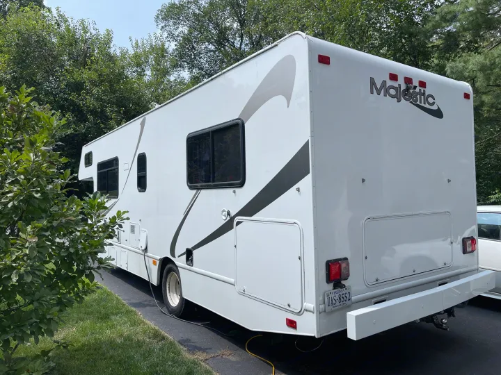 This white Majestic RV rental, a large motorhome with Virginia plates, is parked outdoors.. Other Other 2017
