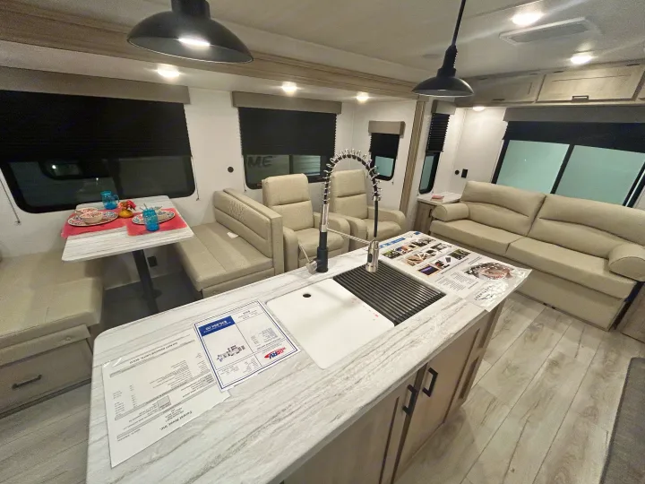 Spacious RV interior with modern kitchen, dining, and living areas, ideal for your next rv rental.. East to West Della Terra 2024
