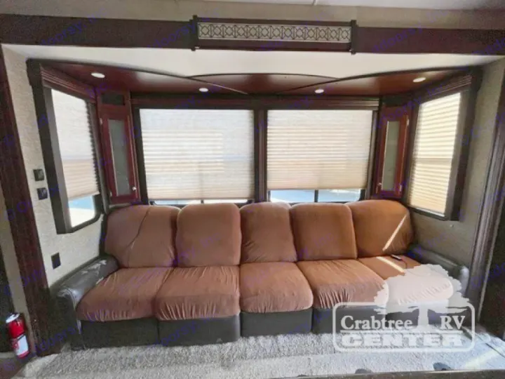 Comfortable brown sectional sofa and large bright windows define this inviting RV living area, great for your next rv rental.. Heartland Road Warrior 425 2016