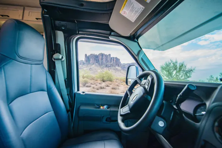 Inside an RV rental, a stunning view of rugged desert mountains, ideal for scenic road trips and adventure.. Nexus Other 2026