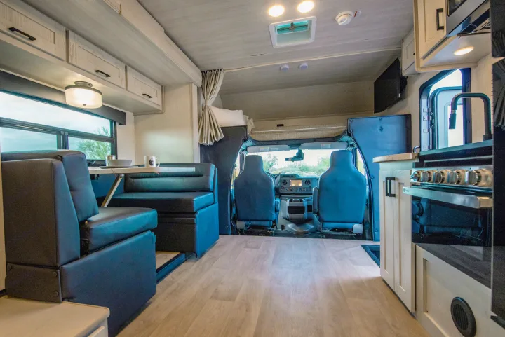 Explore this comfortable rv rental interior featuring a full kitchen, dining booth, & front cabin.. Nexus Other 2026