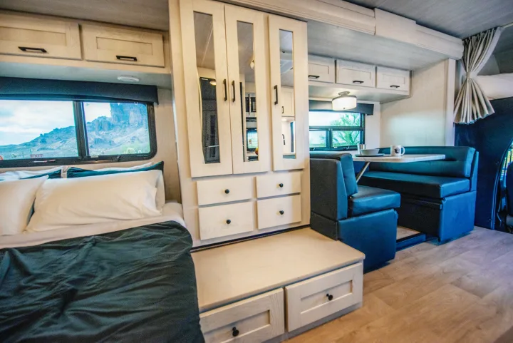 Enjoy travel in this clean RV rental, featuring a full bed, storage, and a dinette by a large window with mountain views.. Nexus Other 2026