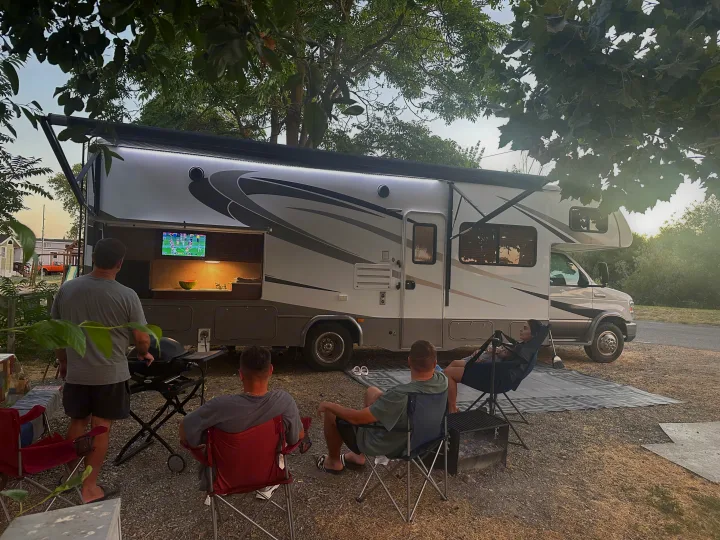 Experience outdoor living with an RV rental: grilling, watching sports on the RV's TV, and relaxing at camp.. Forest River Forester 2861DS 2016
