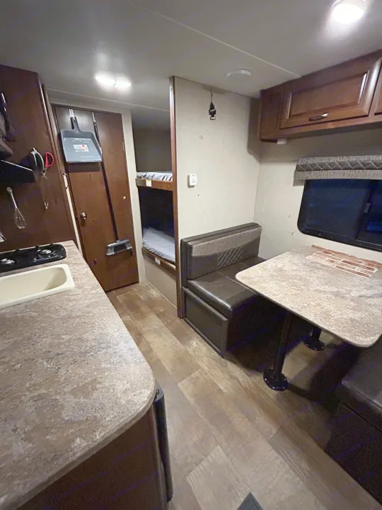 Cozy RV rental interior with kitchen, dinette, and bunk beds. Perfect for family adventures on the road.. Crossroads RV Z-1 Lite 2017