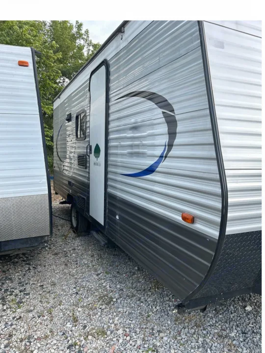 Two travel trailers, one grey with a graphic, parked on gravel. Ideal for your next RV rental adventure.. Crossroads RV Z-1 Lite 2017