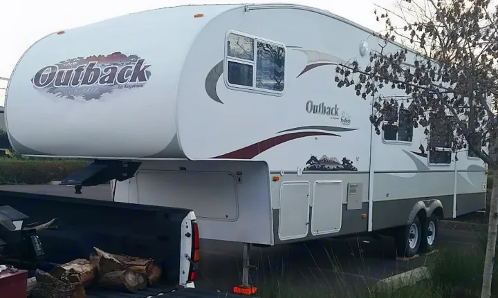 Keystone Outback fifth-wheel RV rental parked with a truck, ready for outdoor adventures.. Keystone RV Outback Sydney 2007