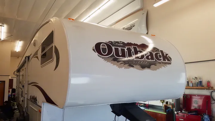 White Outback Keystone fifth-wheel RV in a service bay. Ready for its next journey as an rv rental.. Keystone RV Outback Sydney 2007
