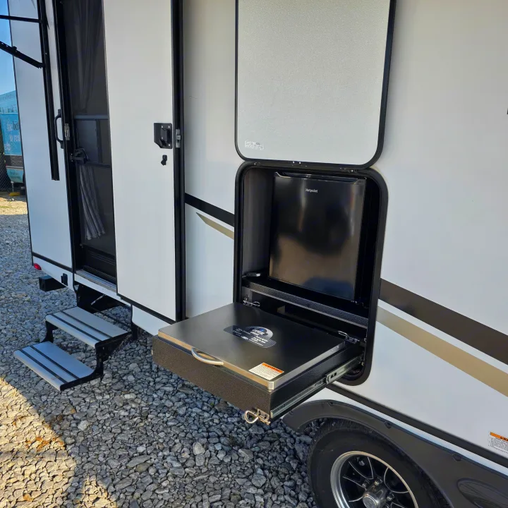 This RV rental features a convenient outdoor kitchen with a Hotpoint mini-fridge & Capital Grille, enhancing your camping experience.. Crossroads RV Sunset Trail Super Lite 2022