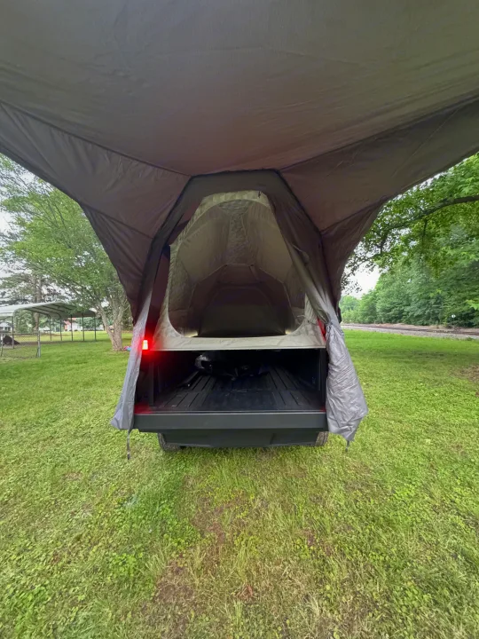 Unique truck bed tent setup, a compact alternative to an RV rental, ready for outdoor adventures.. Tesla Cybertruck 2025