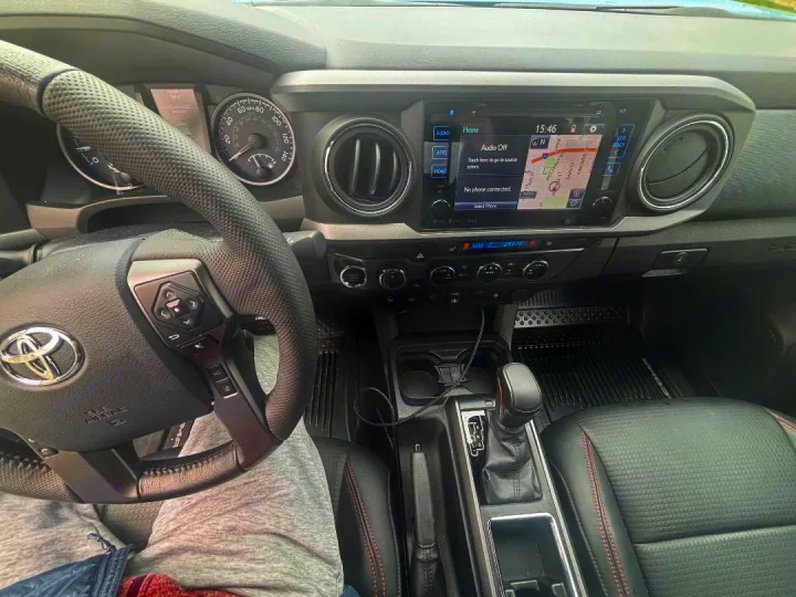 Modern car interior showing dashboard, steering wheel, and infotainment screen with a map. Prepping for an rv rental trip.. toyota Tacoma 2018
