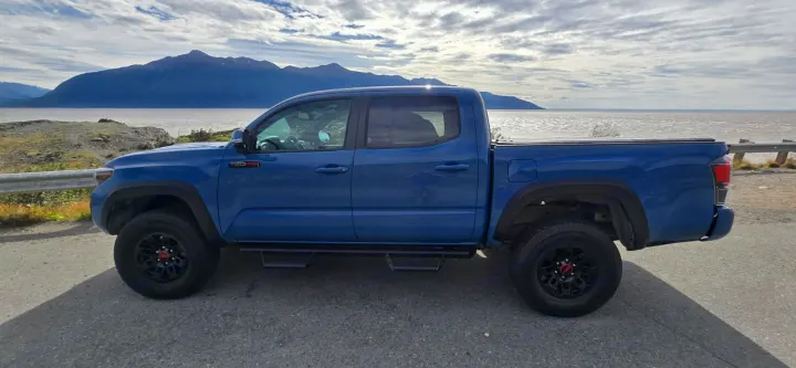 Start your journey in this blue pickup truck by mountains & lake. Perfect for adventures, an alternative to an RV rental.. toyota Tacoma 2018
