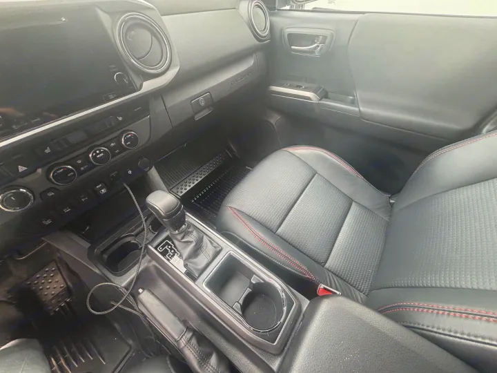 Inside a modern car: dashboard, center console, passenger seat, and all-weather mats. Spacious comfort like an RV rental.. toyota Tacoma 2018