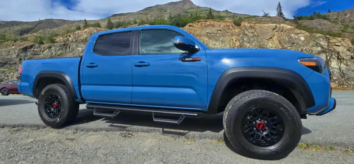 This blue Toyota Tacoma pickup truck is adventure-ready, perfect for exploring before your next RV rental journey.. toyota Tacoma 2018