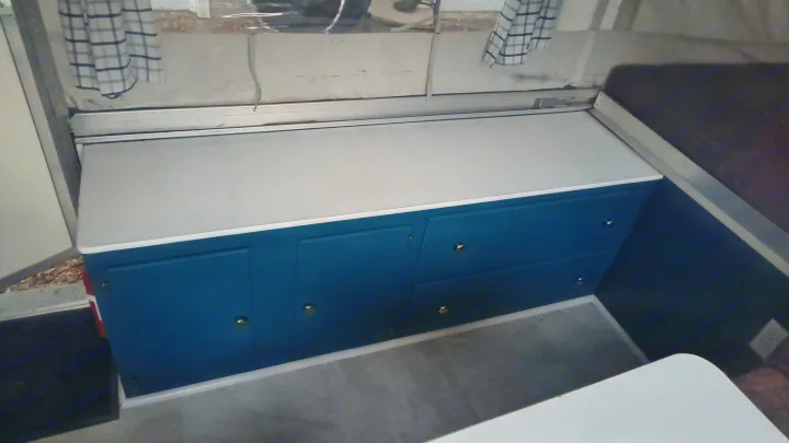 RV rental: Renovated interior with vibrant blue cabinets, white countertop, and cozy sleeping area.. Coleman Destiny Santa Fe 1996