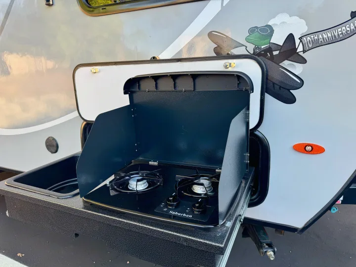 This RV rental features a convenient outdoor kitchen: a two-burner stove, sink, and prep area. Ideal for camping meals.. Forest River RPod 189 2019