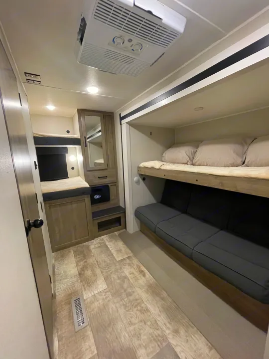 Inside this **rv rental**, find comfortable bunk beds, a convertible sofa, storage cabinets, and an AC unit for your travels.. Forest River Palomino Puma 2024