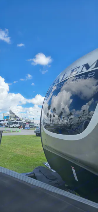Experience a scenic RV rental! Bright blue sky, white clouds, and palm trees reflect on this Forest River Salem Hemisphere near a stadium.. Forest River Salem Hemisphere 2021