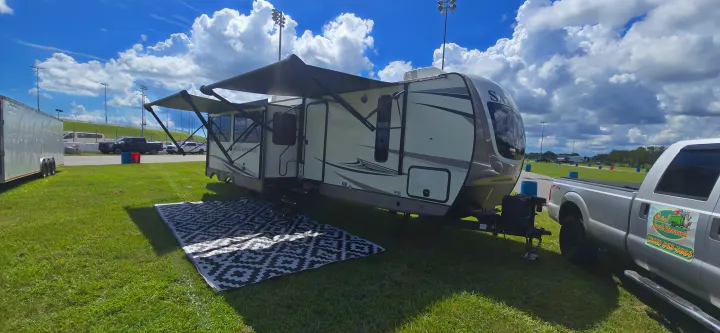 Spacious RV rental, a Forest River Hemisphere travel trailer, parked at a sunny outdoor site with awnings out.. Forest River Salem Hemisphere 2021