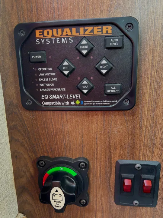 RV rental controls: Equalizer Systems Smart-Level for automatic leveling, plus battery disconnect and accessory switches.. Forest River Sunseeker LE 2022