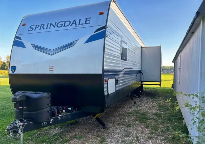 Explore the outdoors! This large Springdale travel trailer, ready for rv rental, offers ample space with its extended slide-out.. Keystone RV Springdale 2022