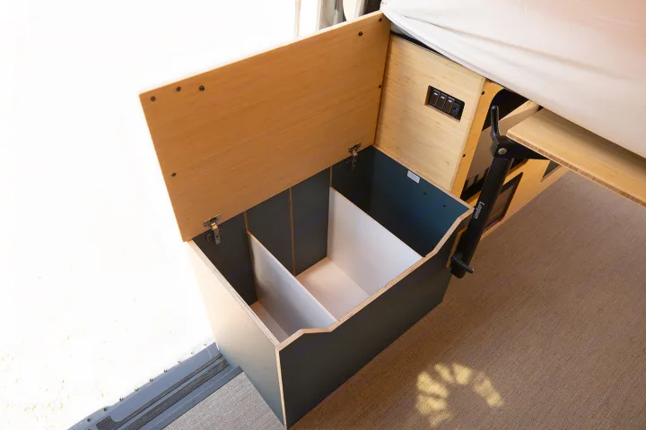 See efficient storage in this RV rental: an open-lid box with interior dividers and a pull-out table arm.. Geotrek Flatiron Summit 2025