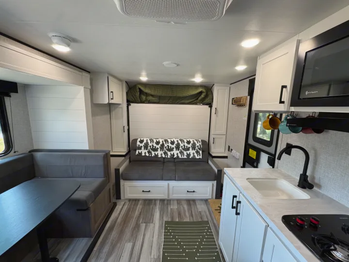 Comfortable RV rental interior showing a modern living space with kitchen, dinette, and murphy bed.. Jayco Jay Flight 197MB 2025