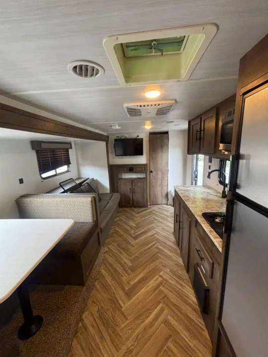 Spacious RV rental interior with full kitchen, dinette, and living area. Perfect for your next adventure!. Forest River Wildwood X-Lite 2023