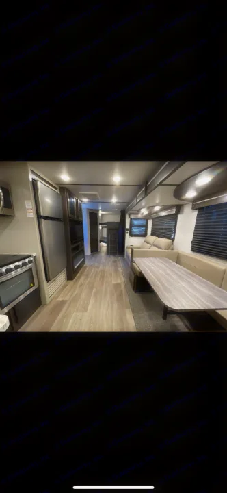 Spacious RV rental interior with a modern kitchen, dining area, and bunk beds, offering a comfortable travel experience.. Crossroads RV Cruiser aire  CR28BBH24 2024