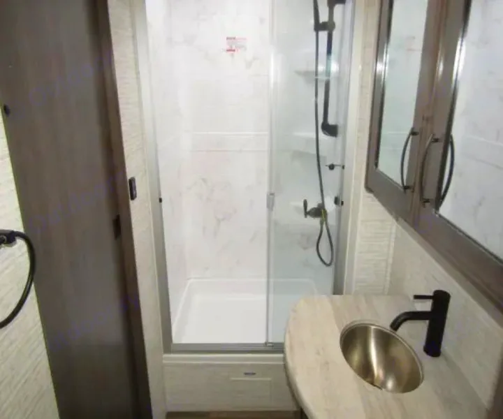 This RV rental's modern bathroom features a glass shower, sink, and storage cabinet, ready for your adventure.. Jayco Precept 2025