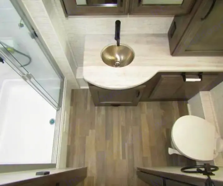 RV rental bathroom: modern sink, shower, and toilet. Overhead view of efficient layout with wood-look floor.. Jayco Precept 2025