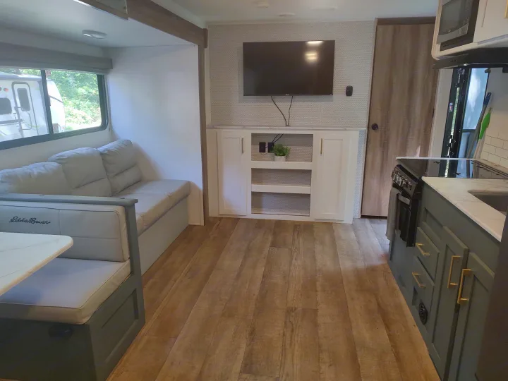 Step inside this modern rv rental! Experience a bright living space with a dining booth, sofa, TV, and full kitchen.. Heartland RVs Eddie Bauer 261BHC 2024