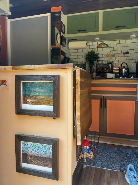 RV rental interior: compact kitchen with green cabinets, tiled backsplash, and a fold-out table, ideal for smart travel.. Mercedes Sprinter Motorhome Campervan RV 2022