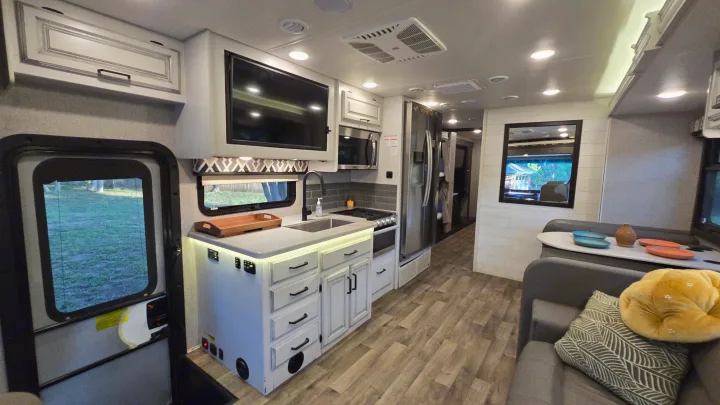 Explore a spacious RV rental interior, featuring a modern kitchen, cozy living room, and stylish details.. Entegra Coach Vision XL 2021
