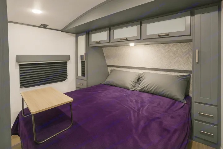 Modern RV rental bedroom: purple bed, overhead storage, mirrored cabinet, and window shade.. Keystone RV Bullet Ultra Lite 2022