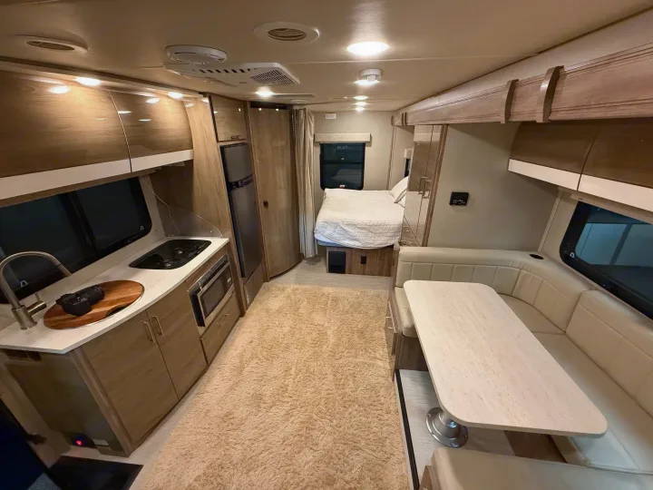 This RV rental features a full kitchen, U-shaped dinette, and rear bedroom. Bright, modern interior for your travels.. Entegra Coach Qwest 2019