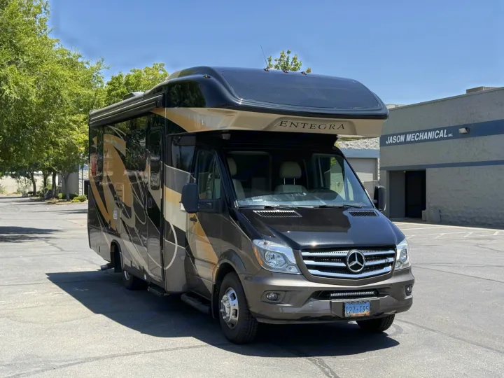 Sleek Entegra Mercedes-Benz Sprinter Class C RV for rental, featuring a two-tone design, parked in a sunny lot.. Entegra Coach Qwest 2019