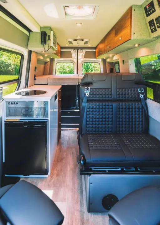 Spacious RV rental interior with kitchen, bed, & flexible seating. Perfect for your next comfortable road trip adventure.. Storyteller Overland Storyteller Overland Class B 2021