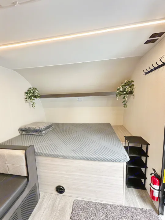 Modern RV rental interior with a comfy bed, LED lighting, and thoughtful details, creating a cozy and functional sleeping space.. Heartland Mallard 2025