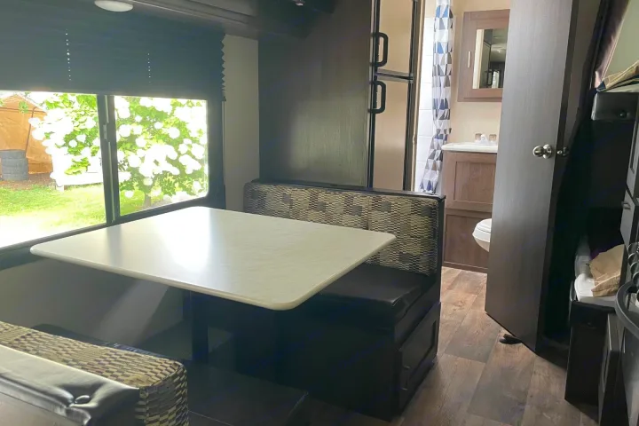 Spacious RV rental interior: Dinette, window view, kitchen, bath, and bunks ready for your adventure.. Forest River Wildwood X-Lite 2018