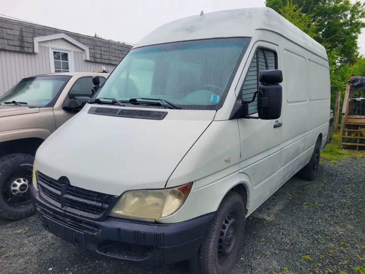 White cargo van, likely for RV rental conversion, parked on a gravel lot.. Mercedes Sprinter 2006
