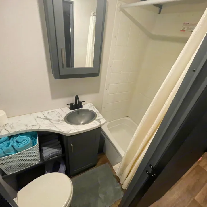 Clean RV rental bathroom with sink, mirror, toilet, and shower/tub combo.. Keystone RV Bullet Ultra Lite 2022