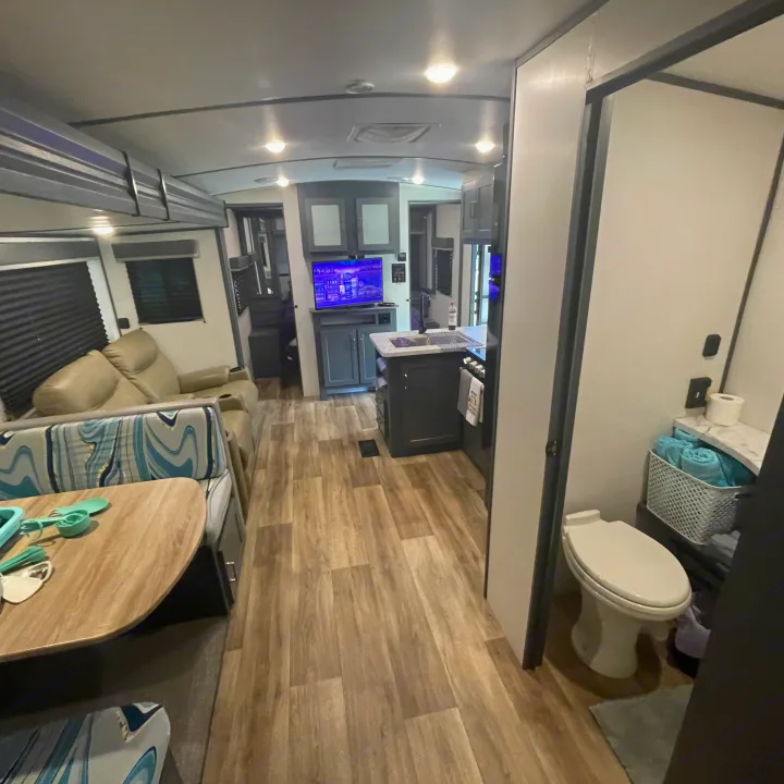 Modern RV rental interior: a full kitchen, dining area, comfortable living space, and bathroom.. Keystone RV Bullet Ultra Lite 2022