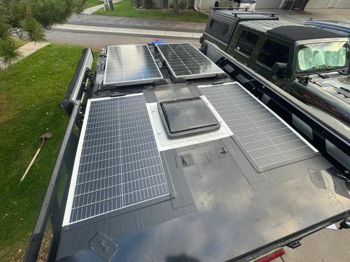 Overhead view of an overland vehicle's roof, featuring multiple solar panels & a vent. Great for an rv rental or adventure trip.. Mission Overland Summit 2022