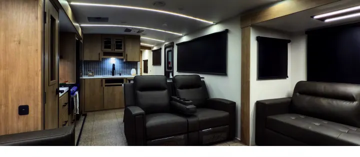 Modern RV rental interior showcasing a full kitchen, comfortable gray reclining seats, and spacious living area.. Grand Design Imagine 3100RD 2025