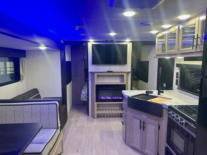 Step inside this stylish RV rental with blue ambient lighting. Full kitchen, cozy dinette, and living area with TV/fireplace.. Forest River Cherokee Grey Wolf 2026